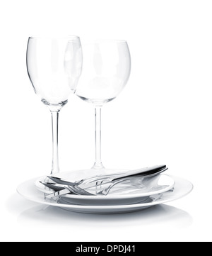 Silverware or flatware on plates and wine glasses. Isolated on white background Stock Photo