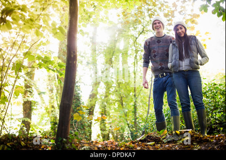 Young couple walking in forest Stock Photo