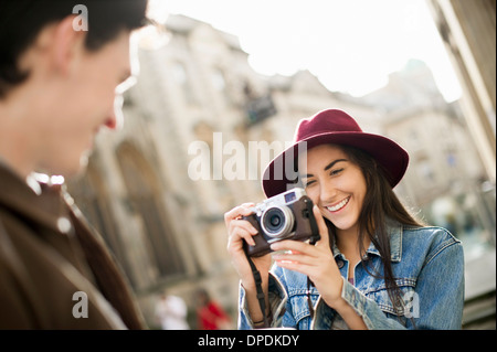 Young woman photographing man Stock Photo