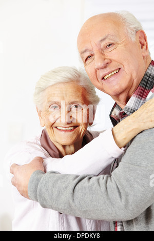 Happy senior citizen couple dancing together and smiling Stock Photo