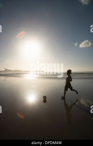 Silhouette of a single man playing football (soccer) at ...