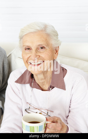 Happy senior citizen with a hot cup of coffee in the morning Stock Photo