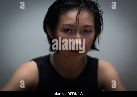 Close up studio portrait of serious young woman Stock Photo