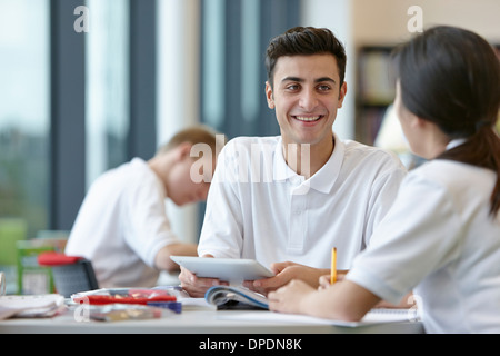 Teenagers working together in school classroom Stock Photo