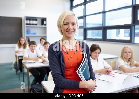Portrait of female teacher with class Stock Photo