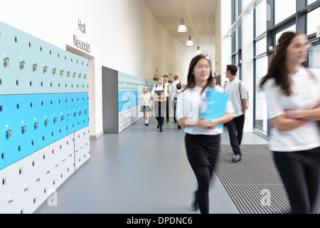 Schoolchildren walking through school corridor Stock Photo