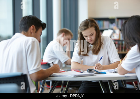 Group of teenagers working in school class Stock Photo