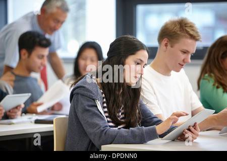 Teenagers working with digital tablets classroom Stock Photo