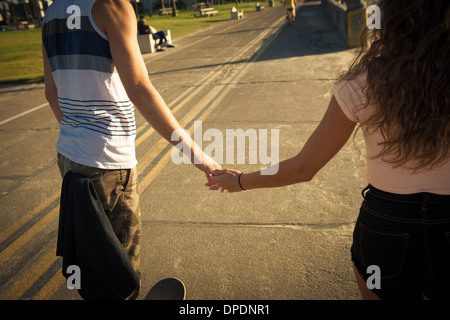 Mid section of couple holding hands Stock Photo