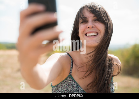 Mid adult woman taking self portrait photograph Stock Photo