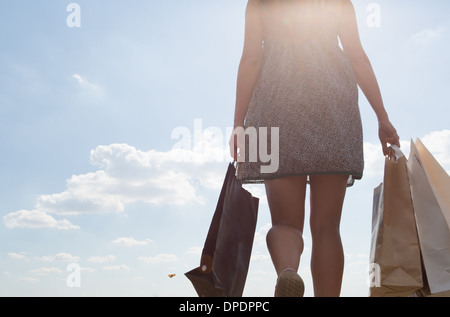 Mid section of woman carrying shopping bags Stock Photo