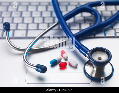Stethoscope and medicine on laptop computer, still life Stock Photo
