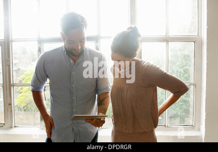 Mid adult couple using digital tablet Stock Photo