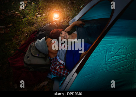 Mature couple lying together in tent Stock Photo