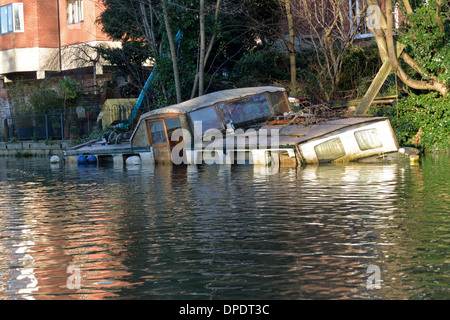 Traditional Broads cruiser sunk at her moorings in Thorpe on the outskirts of Norwich on the River Yare, Broads National Park Stock Photo