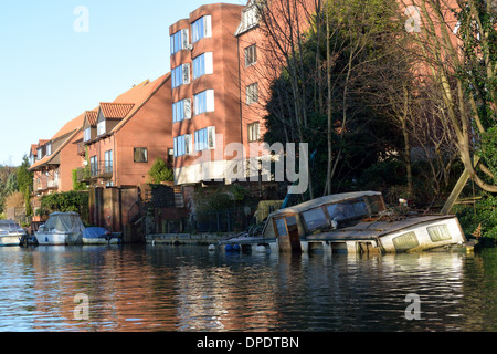 Traditional Broads cruiser sunk at her moorings in Thorpe on the outskirts of Norwich on the River Yare, Broads National Park Stock Photo