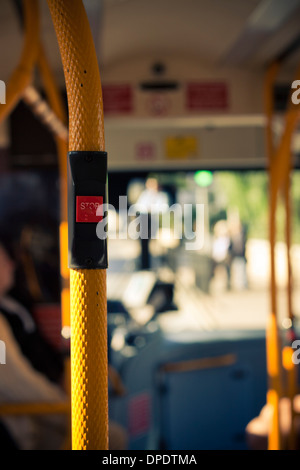 Inside public city bus transport and stop button detail.