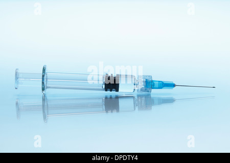 Disposable plastic medical syringe with attached hypodermic needle Stock Photo