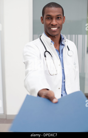 Doctor handing over paperwork Stock Photo
