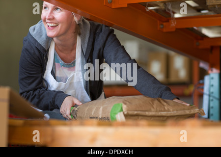 Factory worker handling parcel Stock Photo