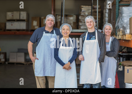 Portrait of four factory workers smiling Stock Photo