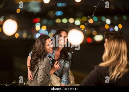 Female friends dancing at rooftop party Stock Photo