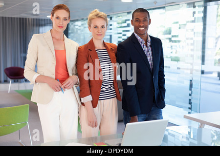 Businesspeople standing in office Stock Photo