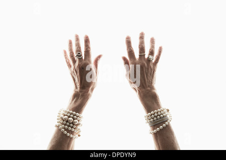 Studio shot of mature woman's reaching hands Stock Photo