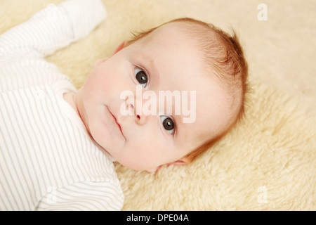 Two month old baby boy lying on furry blanket Stock Photo