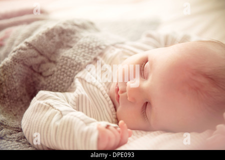 Two month old baby boy asleep in crib Stock Photo