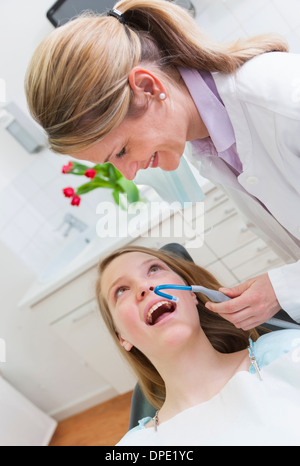 Dentist working on teenage girl Stock Photo