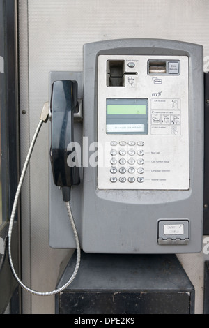 A public telephone kiosk showing the handset and dialing buttons in the UK Stock Photo