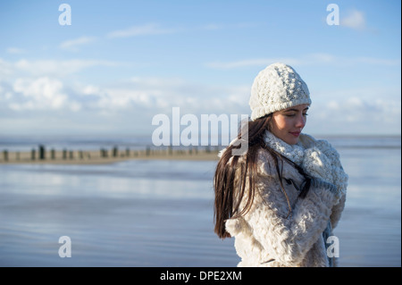 Young woman wearing knit hat, Brean Sands, Somerset, England Stock Photo