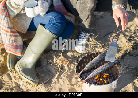 Cooking fish on the beach Stock Photo
