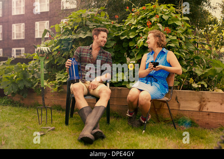 Couple taking a break on council estate allotment Stock Photo