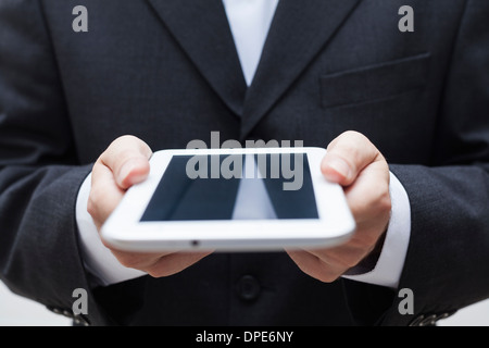 Detail of businessman holding digital tablet. Stock Photo