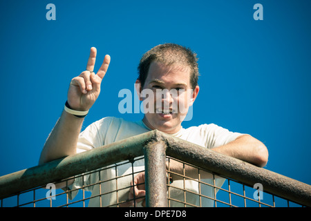 Young happy man gesturing v sign Stock Photo