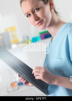 Doctor or radiologist viewing x-ray of broken leg in hospital Stock Photo