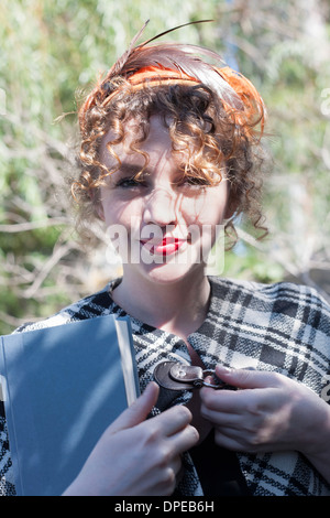 Portrait of young woman holding book in park Stock Photo