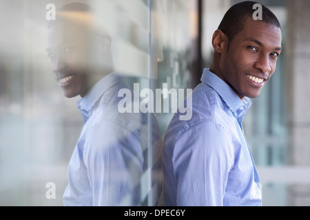 Portrait of businessman leaning against wall Stock Photo