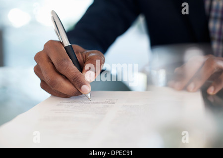 Cropped image of businessman signing paperwork Stock Photo
