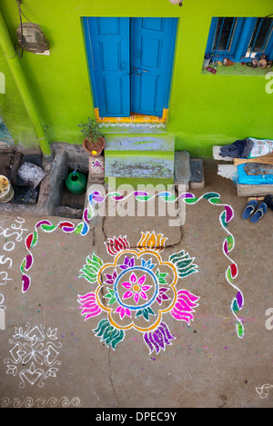 Rural Indian village street covered with Rangoli festival coloured powder designs at Sankranti. Andhra Pradesh, India Stock Photo