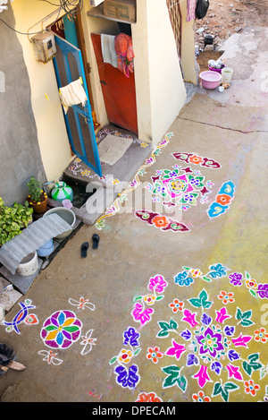 Rural Indian village street covered with Rangoli festival coloured powder designs at Sankranti. Andhra Pradesh, India Stock Photo