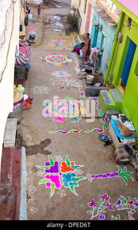 Rural Indian village street covered with Rangoli festival coloured powder designs at Sankranti. Andhra Pradesh, India Stock Photo