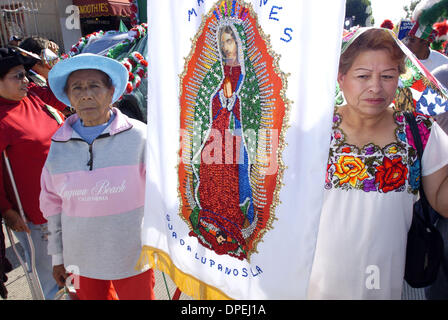 Dec. 03, 2005 - East Los Angeles, California, USA - Catholic faithful take their positions behind a banner prior to the start of the annual procession to honor the Patron Saint of the Americas, the Virgin of Guadalupe, on Saturday, Dec. 3, 2005, in East Los Angeles, CA. (Credit Image: © Brian Cahn/ZUMAPRESS.com) Stock Photo