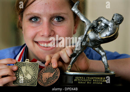 (published 4/12/2006, NC-6; republished 4/28/2006, NI-8) LE girlwrestler254841x001 4-4-2006 Rancho Santa Fe LAUREN THOMPSON, 14, of Rancho Santa Fe, holds her wrestling medals: gold from United States Girls Wrestling Association State Championships, left,  and bronze from United States Girls Wrestling Association National Championships, center,  next to her San Diego Imperial Kids  Stock Photo