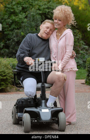 Former Oakland Raider legend Jim Otto hugs his wife, Sally outside