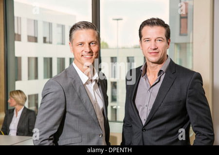 Businessmen standing in conference room Stock Photo