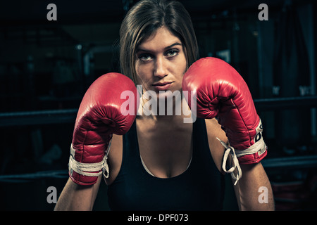 Female boxer wearing boxing gloves Stock Photo