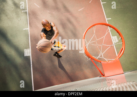 Basketball player shooting Stock Photo